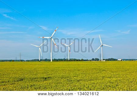 Wind Energy Wowers Standing In The Field In Spring