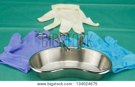 Surgical Equipment On Kidney Bowl And Three Pieces Of Gloves