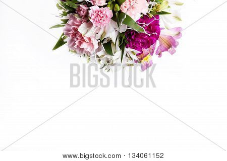 Bouquet from pink and purple gillyflowers and alstroemeria on top of white background