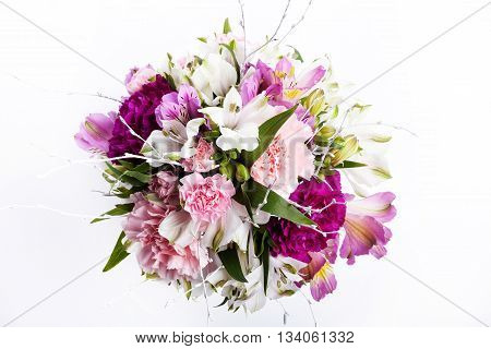 Bouquet from pink and purple gillyflowers on white