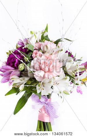 Pastel bouquet from pink and purple gillyflowers and alstroemeria on white background
