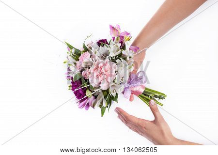 Giving a pink bouquet from gillyflowers and alstroemeria