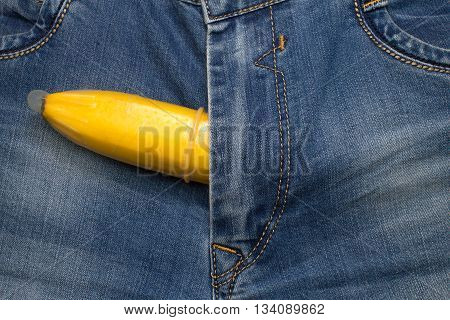 banana fruit in condom inside jeans pants contraceptive concept