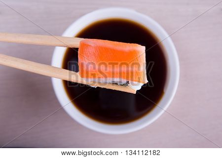 sushi with salmon and a saucer of soy sauce