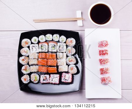large set of sushi on a black plate