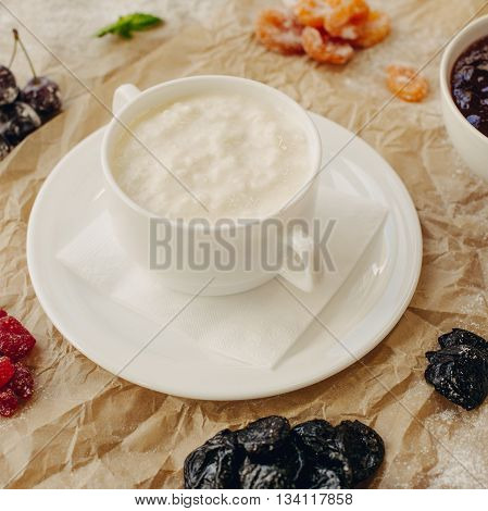 Rice porrige with berries on parchment background.