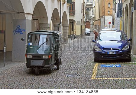 Someone Is Driving A Motor Tricycle On Narrow Street In Padua