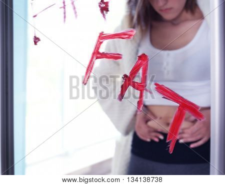 Bulimic young girl feeling fat and ugly