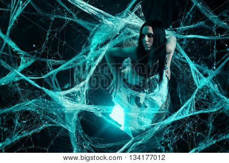 Girl like a spider getting out from the cocoon