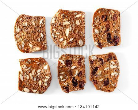 multigrain bread slices with fruits and nuts close-up on white background