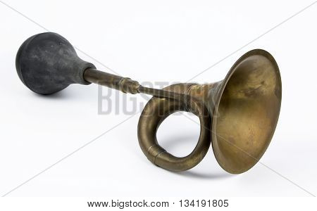 Antique brass car horn on a white background