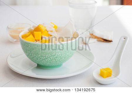 Rice pudding with mango and coconut water in a bowl, khao niaow ma muang White background Copy space Top view