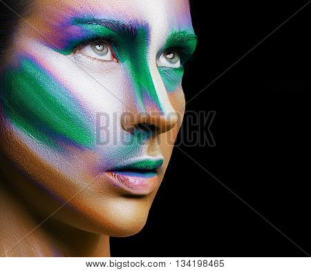 Beautiful fashion woman with bright color face art and body art. Paint on face. Creative portrait
