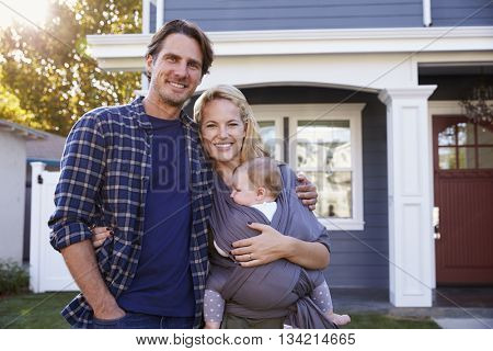 Portrait Of Family Standing Outside House