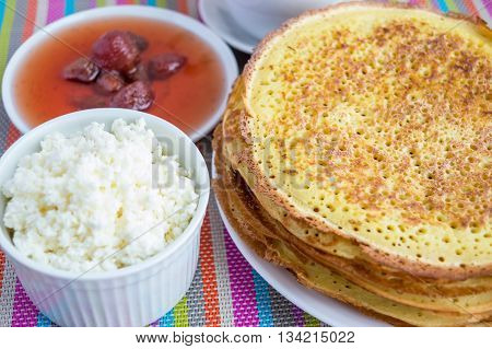 Pancakes with strawberry jam cheese . Close up