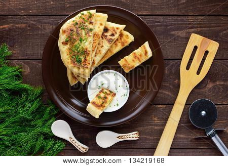 Traditional Georgian cheese pie - khachapuri creamy sauce. The national cuisine of Georgia. The top view.
