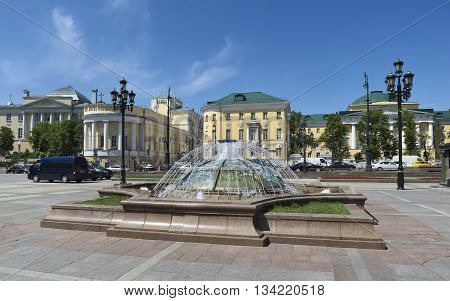 MOSCOW, RUSSIA - MAY 31, 2016: Fountain at the Manezhnaya square a view of the Moscow State University named after Lomonosov cityscape