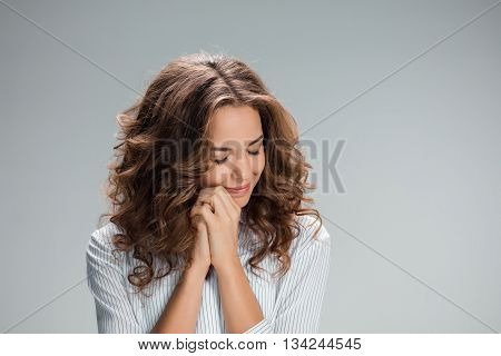 The Woman is looking imploring over gray background