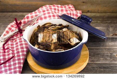 stew in a blue pot on the wooden background tasty meat