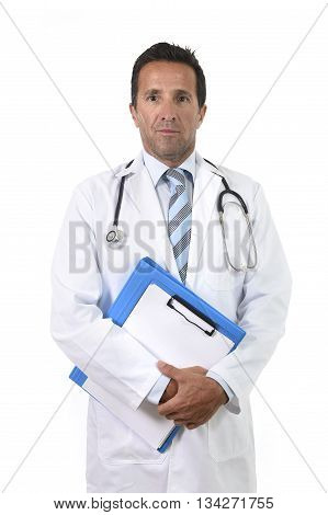 corporate portrait of confident 40s attractive male medicine doctor with stethoscope on shoulders and medical gown standing proud and serious holding clipboard isolated on white background