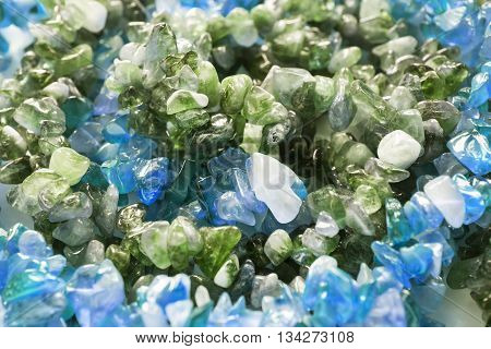 Pieces of nephrite and aquamarine closeup as a background