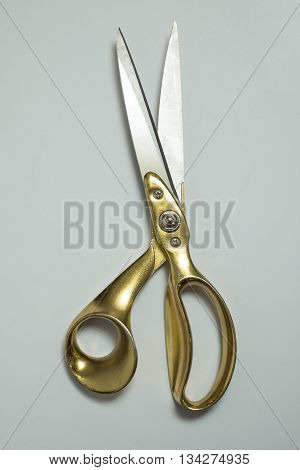 Overhead view of a pair of brass-handled tailor shears