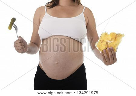 young pregnant woman showing big belly eating chips and holding fork with pickle isolated on white background in pregnancy whim food concept isolated on white background