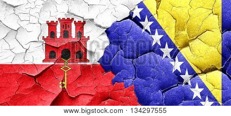 gibraltar flag with Bosnia and Herzegovina flag on a grunge crac
