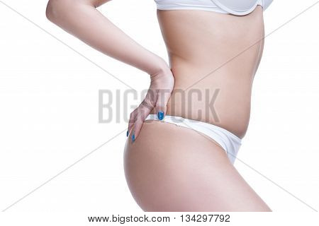 Beautiful female body closeup. Tummy waist buttocks and thighs. Isolated on white background