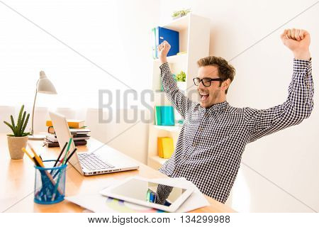Happy Man Completed Task And Triumphing With Raised Hands