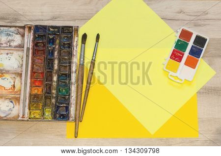 Watercolor Paintboxes And Yellow Pieces Of Paper