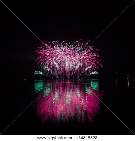 Colorful Fireworks With Reflection On Lake.