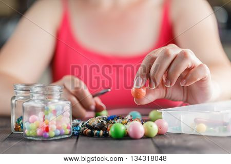 Woman Designing Colorful Necklace With Plactic Beads