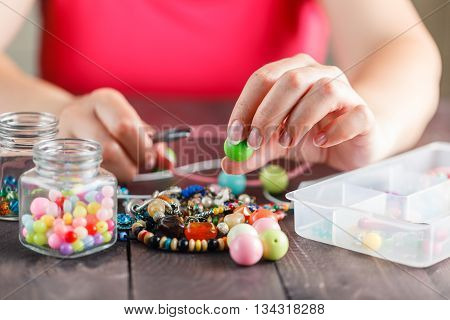 Woman Designing Colorful Necklace With Plactic Beads