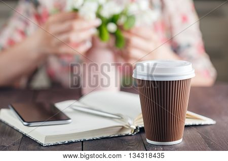 Coffee To Go. White Flowers On The Rustic Background.