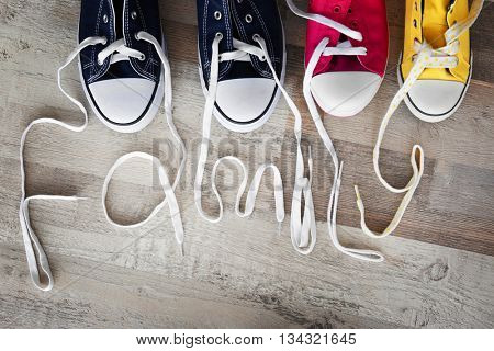 Pairs of shoes on a wooden parquet. Family concept