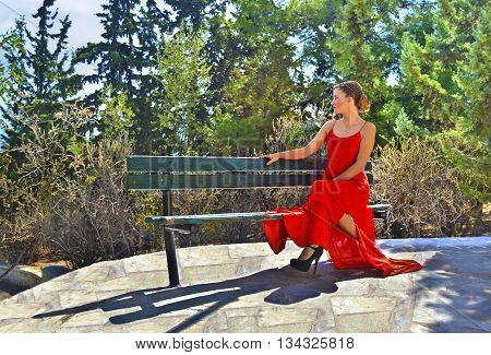 beautiful blond woman formally dressed sitting on a park bench - greek woman portrait