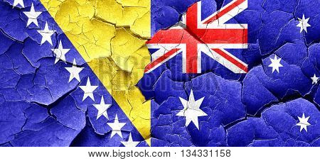 Bosnia and Herzegovina flag with Australia flag on a grunge crac
