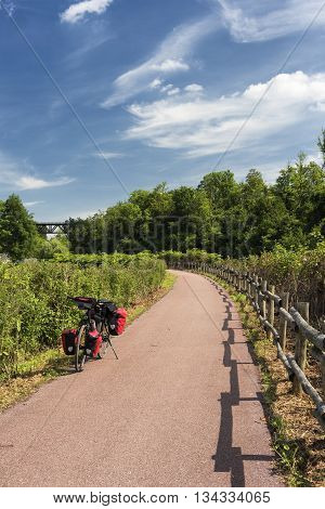 The bicycle path of the Lambro river in Brianza (Lombardy Italy) at spring: a bicycle with red bags
