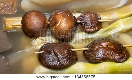 The close up of Taiwanese oden shiitake on stick at food street night market in Taipei, Taiwan.