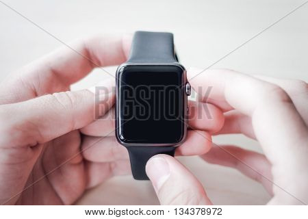 Black smart watches in the hands of