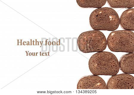 Decorative edging pieces of black rye bread on a white background. Isolated. Border. Pattern. Food background. View from above.