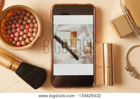 Smartphone With Glamour Insta Photo And Golden Cosmetics - Lipstick, Powder, Blusher, Brush, Perfume