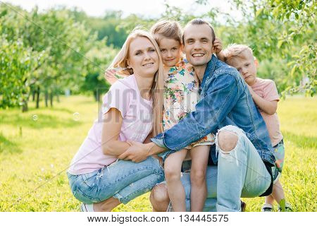 Portrait of young happy family at outdoos
