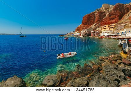 Fishing boats at Old port Ammoudi of Oia village at Santorini island in Aegean sea, Greece