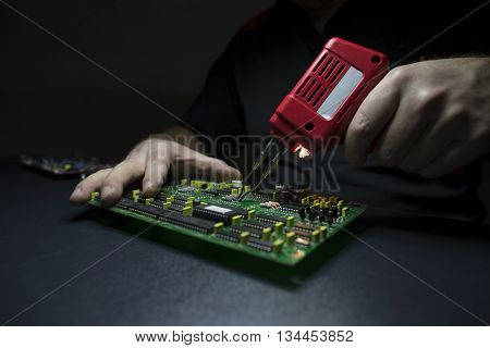 Male hands repairing / fixing computer details
