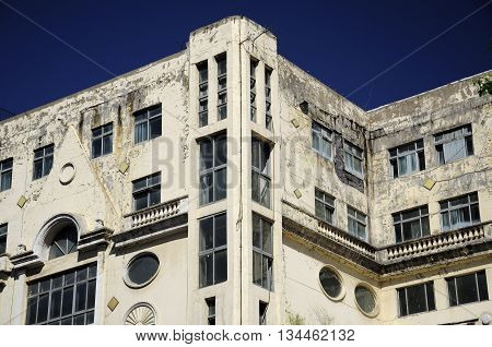 A weathered and old building on Zhongyang pedestrian street within the city of Harbin China in Heilongjiang province on a sunny blue sky day.