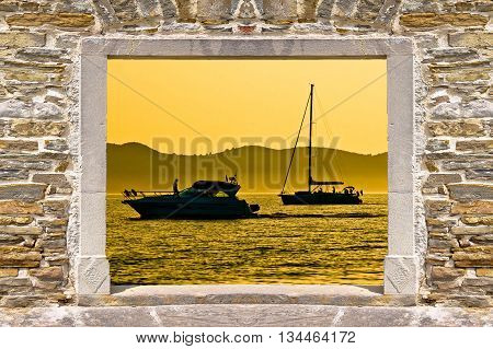 Sunset sailing and yachting through stone wall door view Dalmatia Croatia