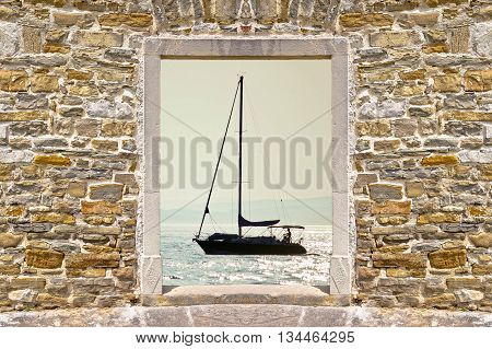 Sailing at sunset through stone wall door view Dalmatia Croatia