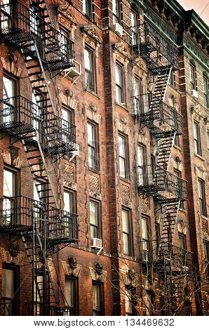New Your City buildings along a street with fire escapes